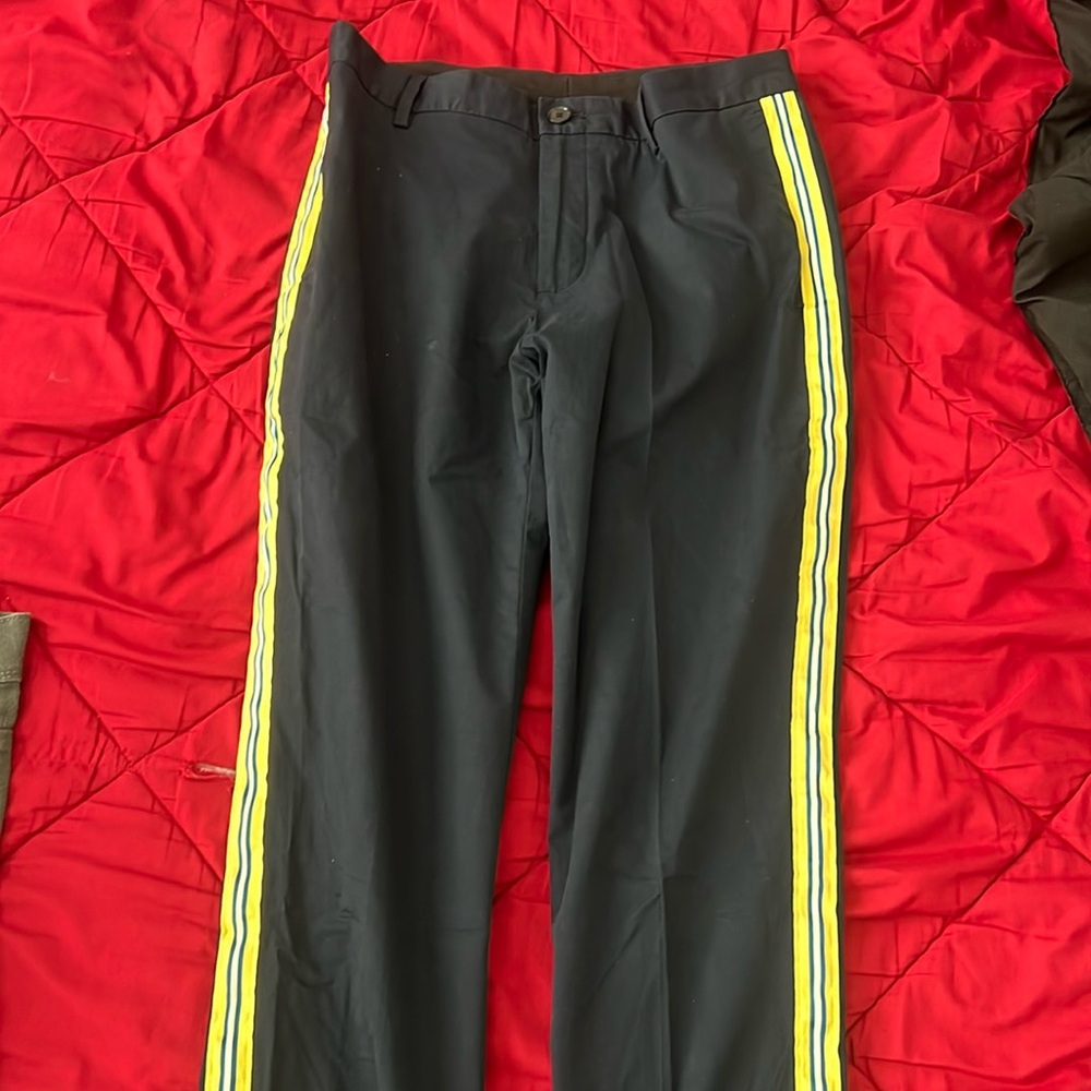 Navy blue dress pants with yellow white and blue side trim